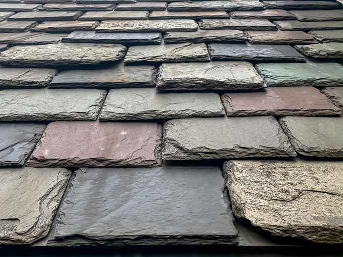 Close-up view of textured slate roof tiles showcasing natural colors.