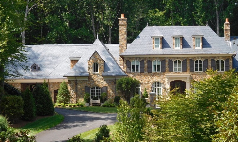 Elegant stone mansion nestled in lush green surroundings