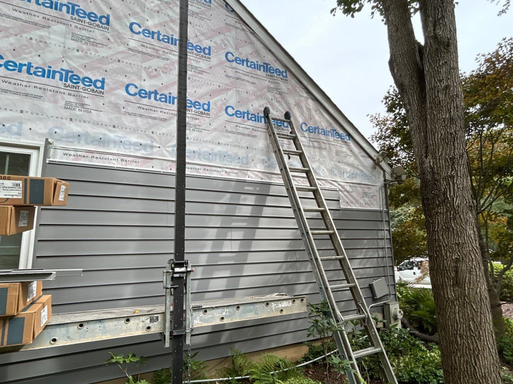 House under construction with ladder and CertainTeed siding