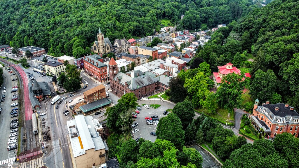 Aerial view of quaint town with historic buildings and lush greenery