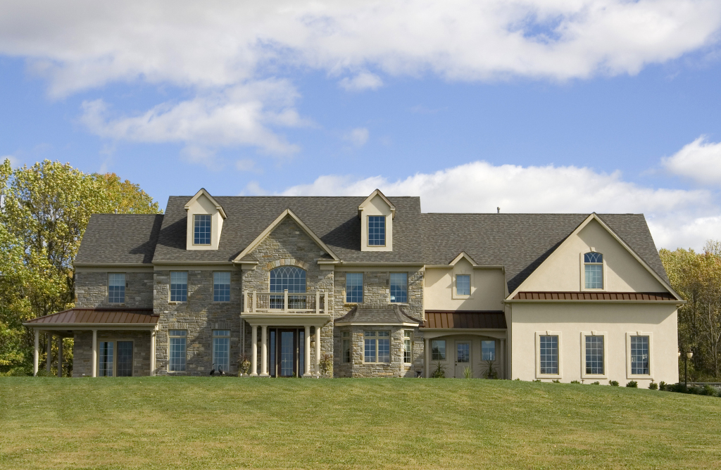 Elegant suburban home with stone facade and large windows