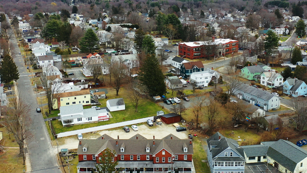 Aerial view of a suburban neighborhood with houses and trees in winter.