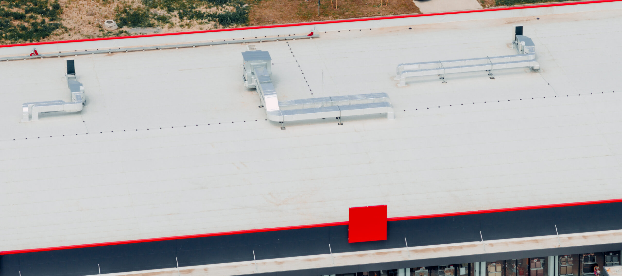 Aerial view of a building rooftop with ventilation systems