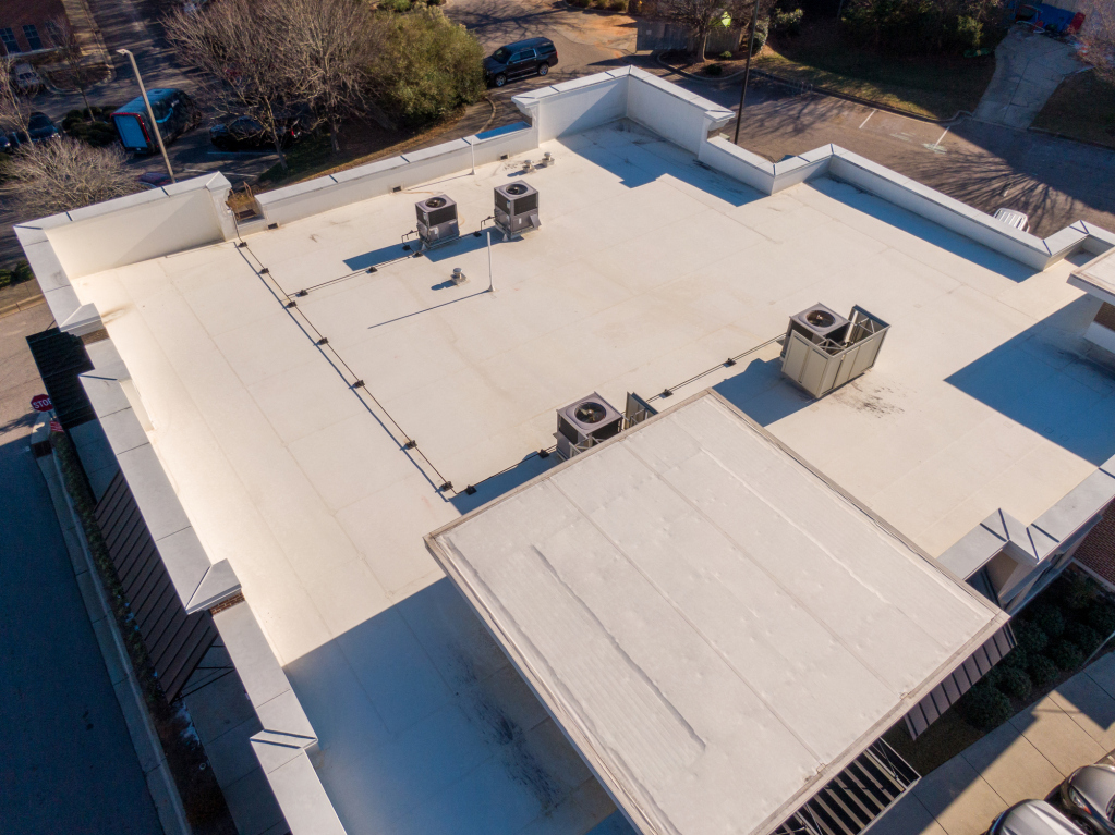 Aerial view of a flat rooftop with HVAC systems.