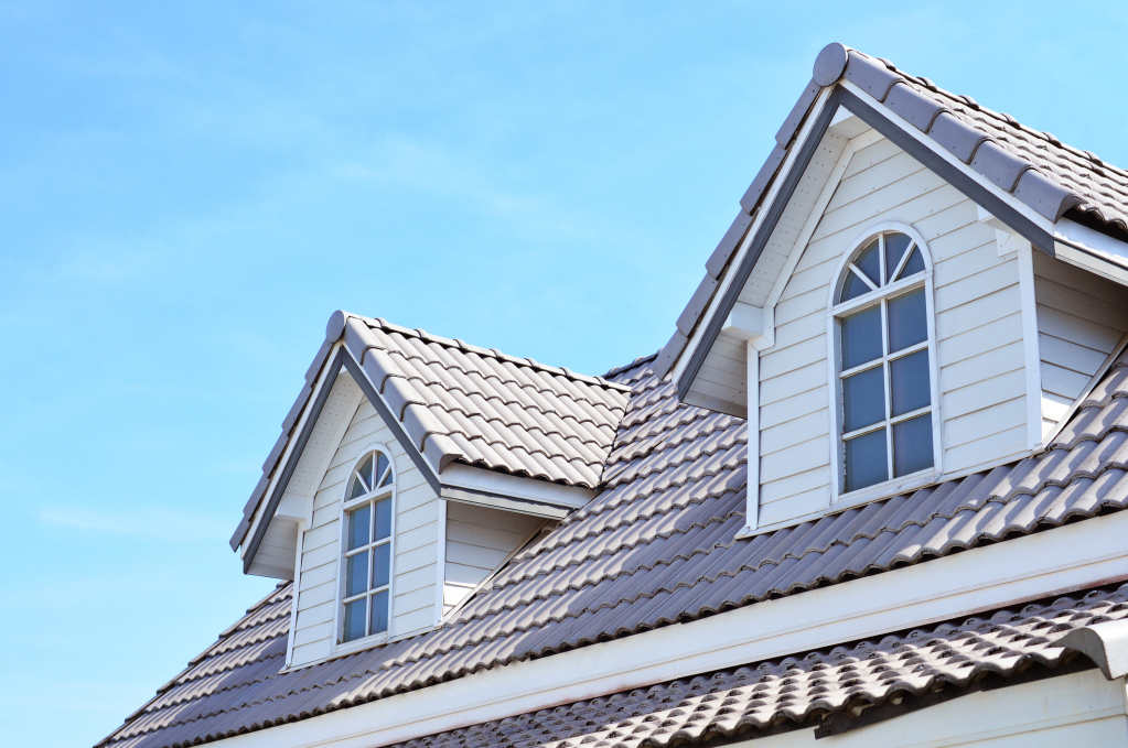 Gabled roof with dormer windows under clear blue sky