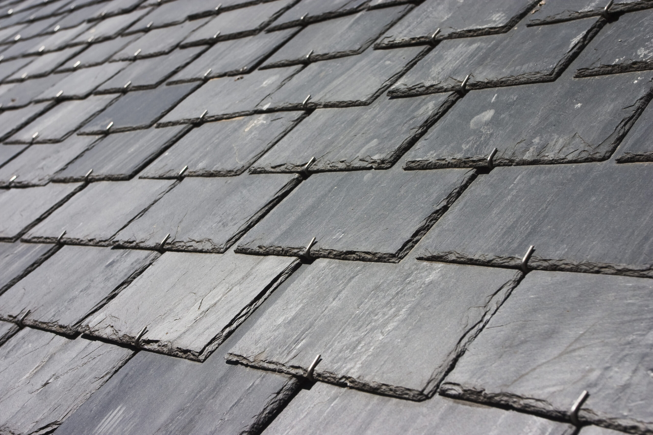 Close-up view of a slate roof with overlapping tiles.